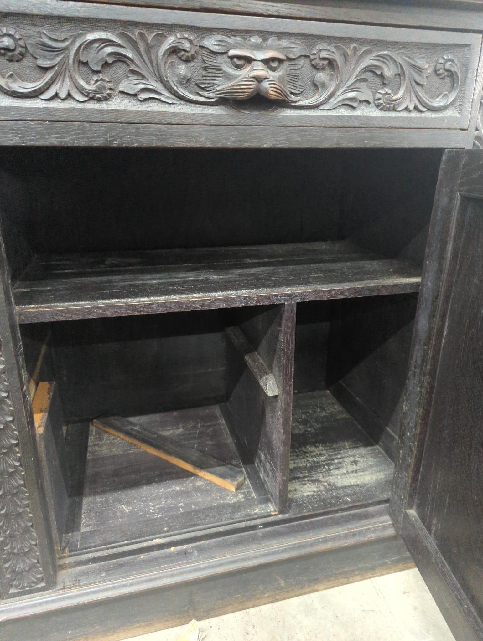 A late 19th century Flemish carved oak mirror back sideboard, width 150cm depth 56cm height 188cm